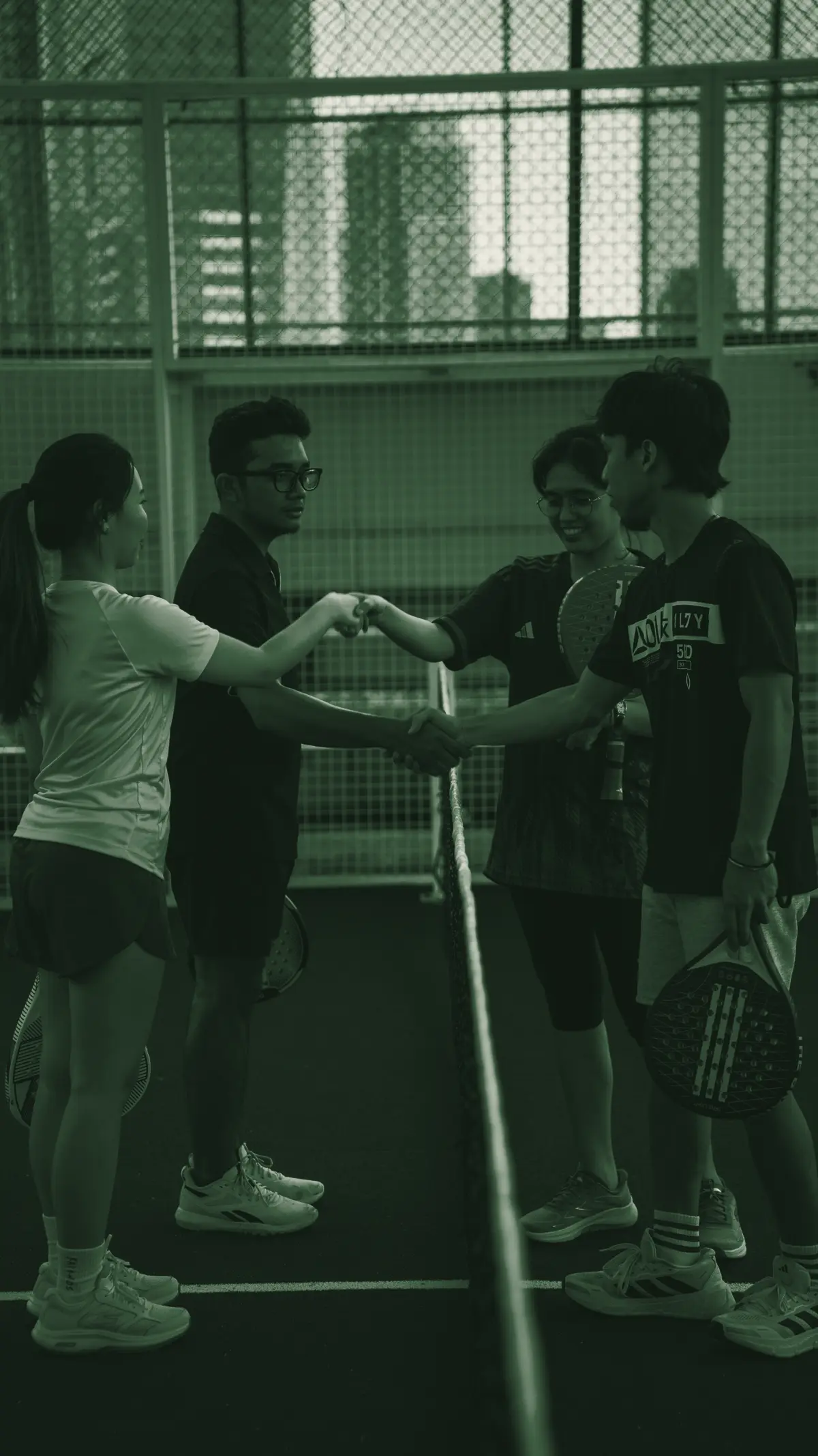 Four players greeting each other across the net