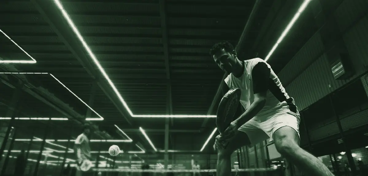 A player ready at the net in an indoor club